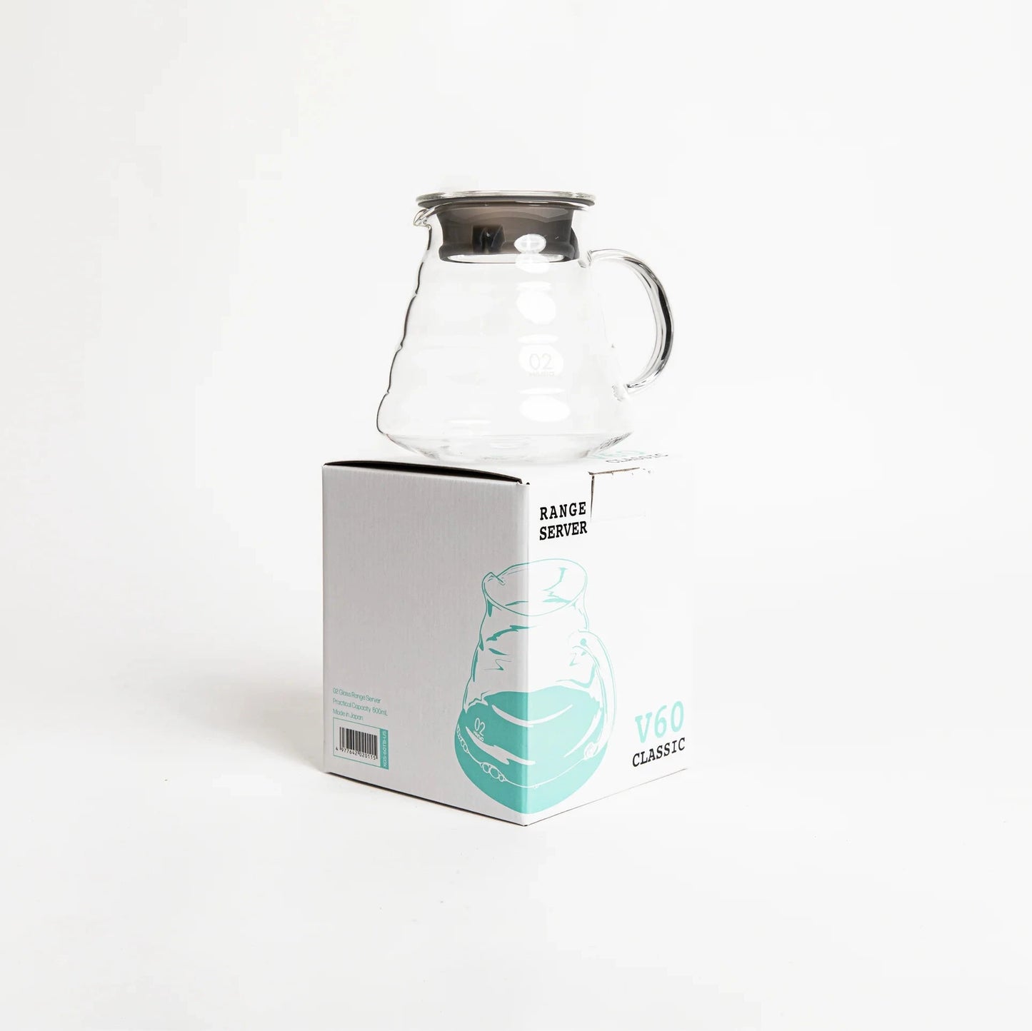 Clear glass carafe on a white background with a branded box.