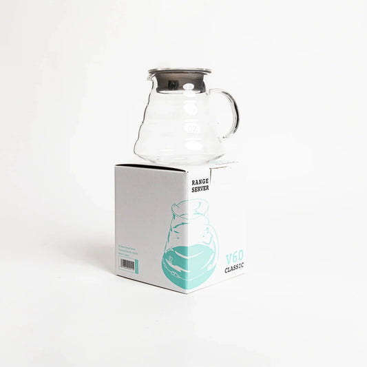 Clear glass carafe on a white background with a branded box.